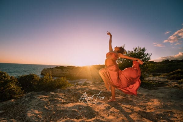 Maternity Photoshoot on a cliff in Portugal with a dancer in a silk scarf