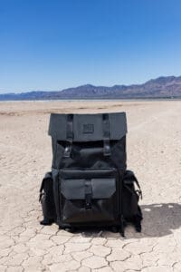 Langly Alpha Globetrotter XC Camera Backpack Bag on the floor in the desert