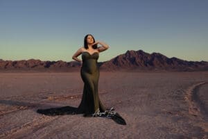 pregnant woman in desert posing with maternity silk scarf